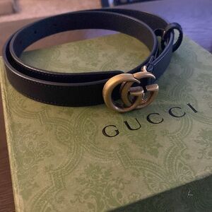 Gently used black and gold gucci belt